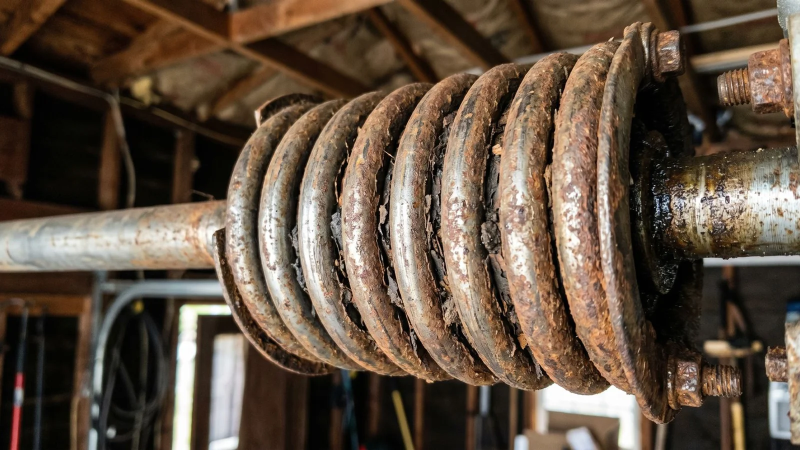 Rusted torsion spring showing oxidation between coils